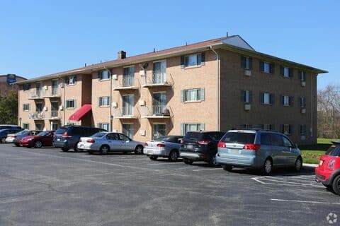 Brick apartment building at King of Prussia Arms with private balconies and resident parking