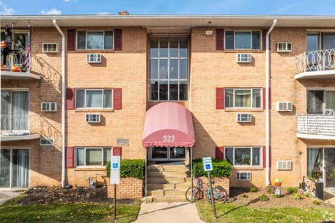 Front entrance to building 523 at King of Prussia Arms, with a covered awning and brick walkway