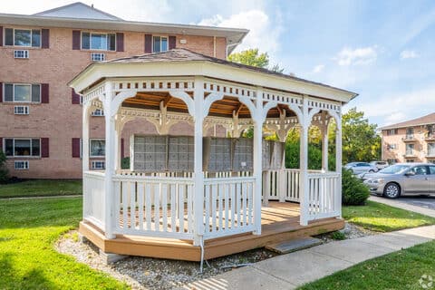 Covered gazebo and shaded seating area on the King of Prussia Arms lawn